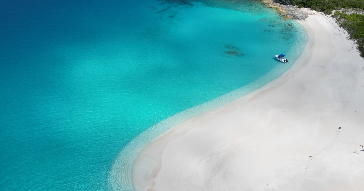 Aerial view of a white-sand Exuma beach and turquoise water