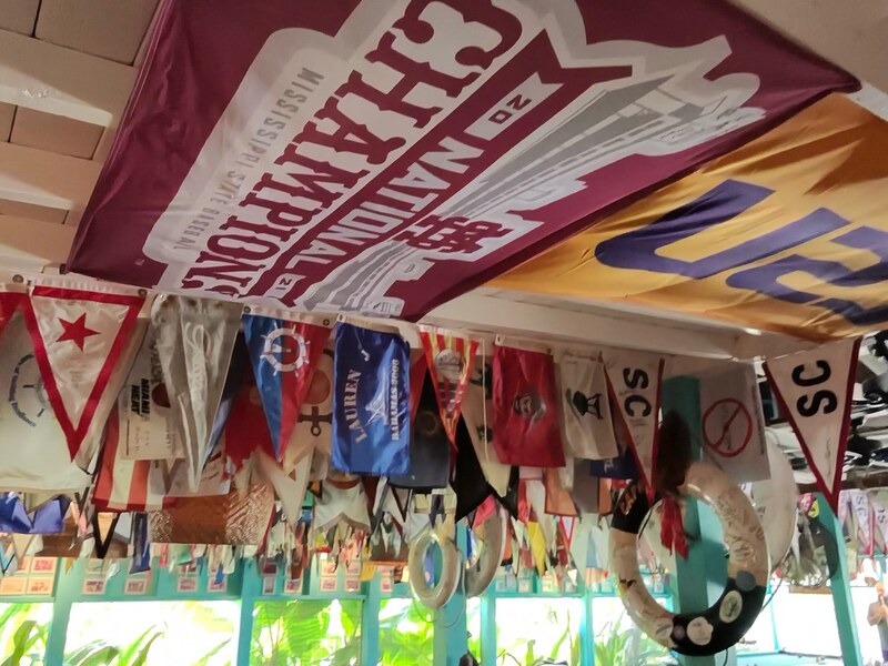 Colorful nautical flags and dining tables inside an Exuma restaurant